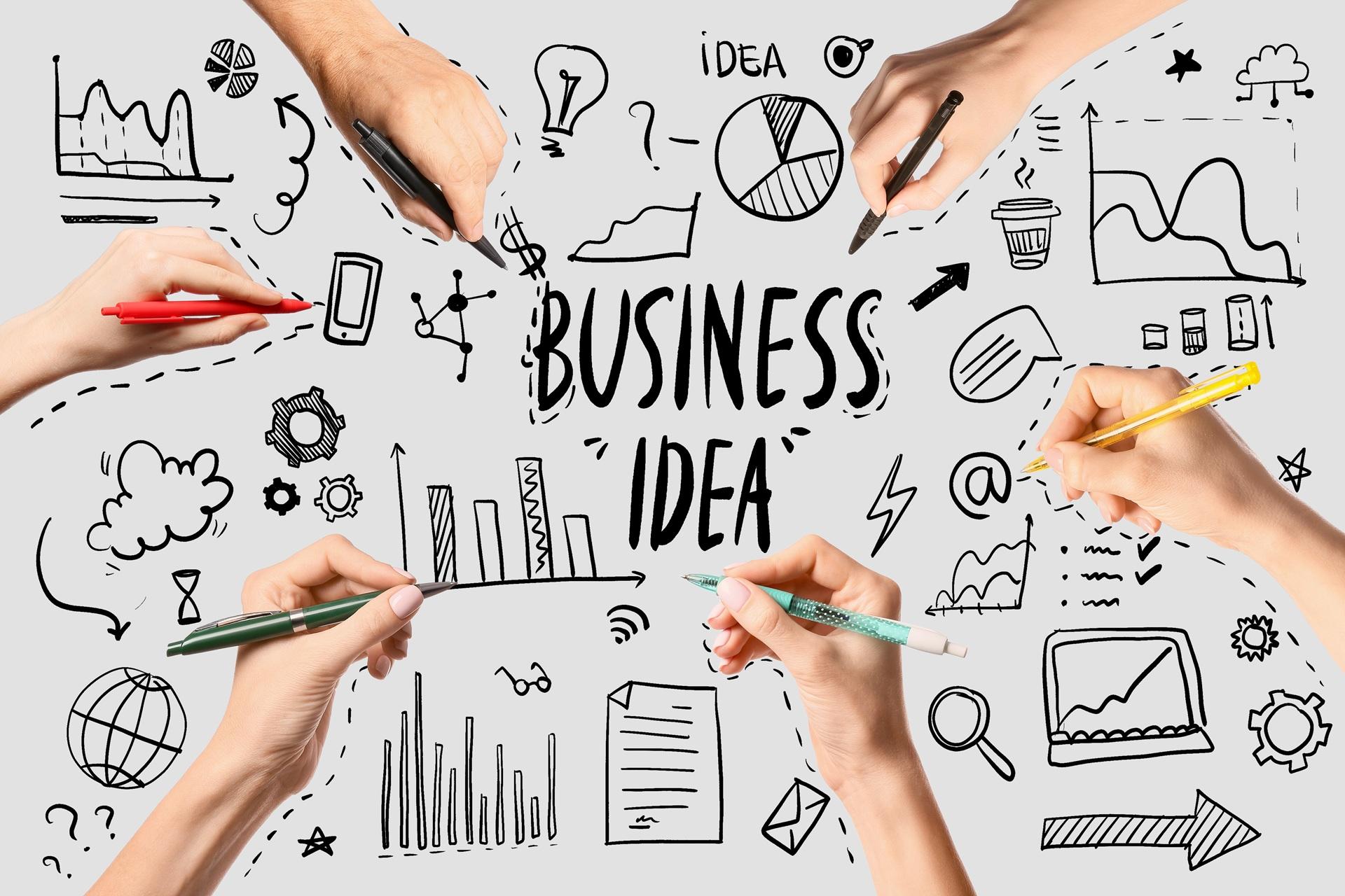 Mehrere Hände zeichnen Symbole und Ideen rund um Businessplan | Lohnabrechnung Outsourcing